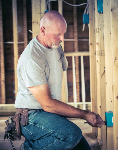 Photo of Marty installing electrical wiring
