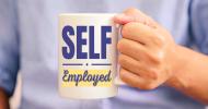 A person holding a mug that says, Self-employed.